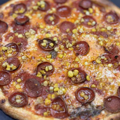 A whole pepperoni pizza with jalapenos