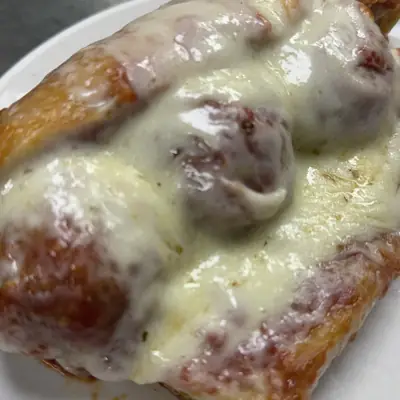 A meatball sub covered in melted cheese