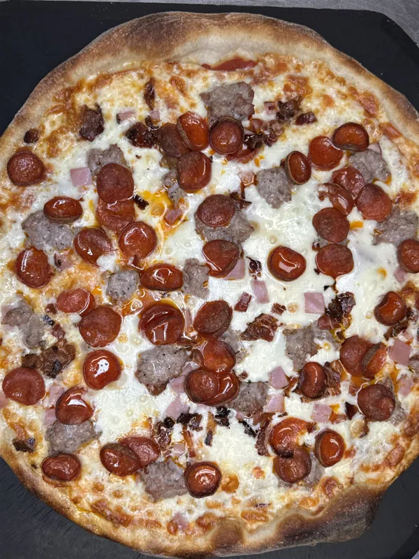 Whole pizza loaded with pepperoni and sausage