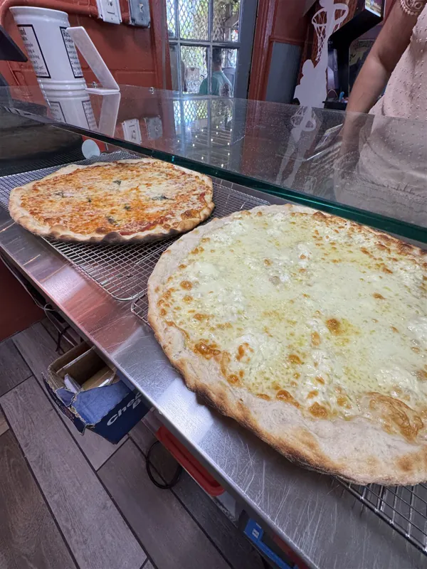 Whole pies waiting at the slice counter