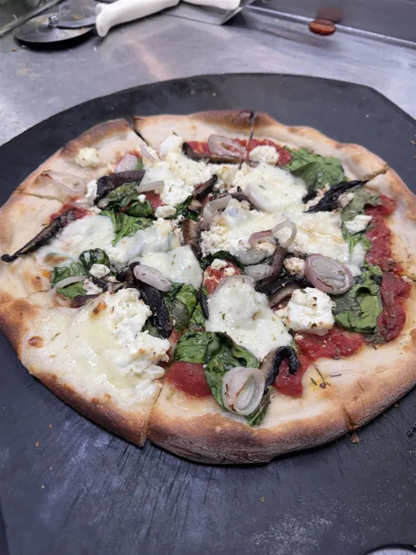 White pizza with ricotta, spinach and portobello mushrooms