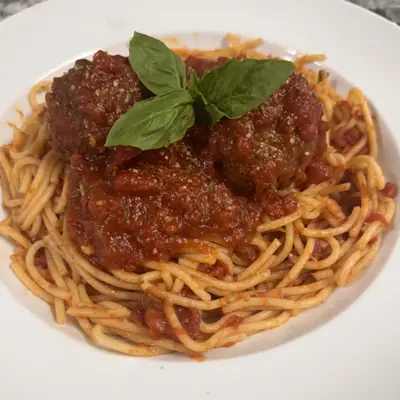 Spaghetti and meatballs with basil